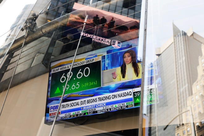 News of Trump Media & Technology Group public trading is seen on television screens at the Nasdaq Marketplace on March 26, 2024 in New York City.