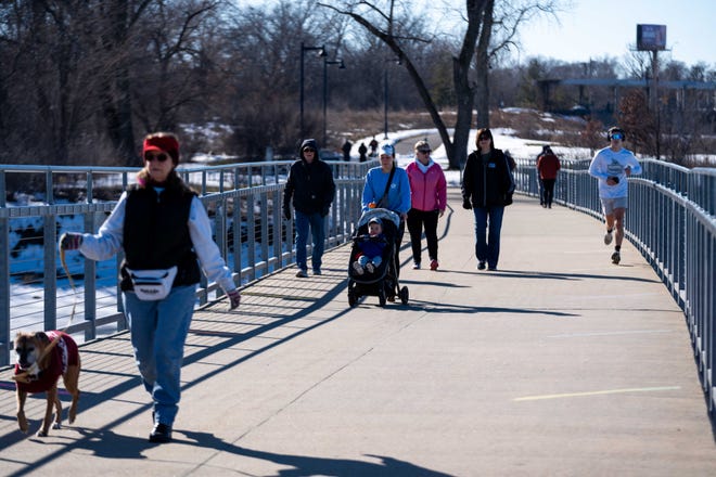 Residents head outside as they enjoy the warmer weather as afternoon temperatures rise to 48 degrees Monday, Jan. 29, 2024, at Gray's Lake Park in Des Moines.