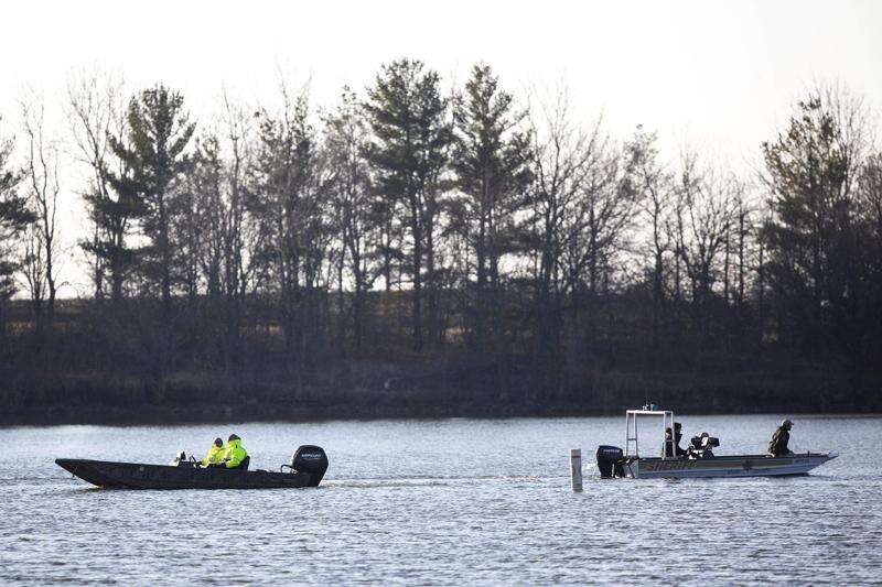 Law enforcement resumes the search March 29, 2021, for a missing Iowa State University Crew Club member at Little Wall Lake in Hamilton County. Two of five students aboard a crew club boat drowned March 28. (Kelsey Kremer/Des Moines Register via AP)