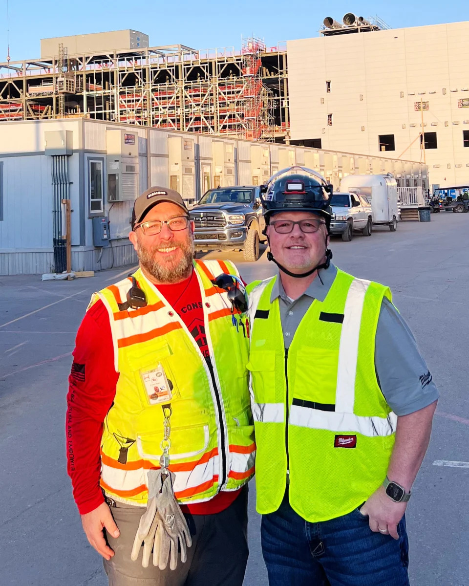 Josh Vitale and Justin Azbill in front of a construction site (Courtesy Justin Azbill)