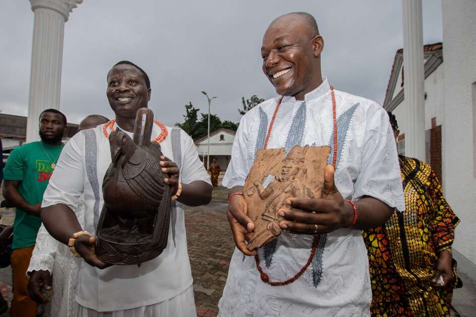 Palace dignitaries of the Benin Royal Court carry the Benin Bronzes on July 15 during a restitution ceremony with the University of Iowa Stanley Museum of Art in Benin City, Nigeria. The Stanley Museum became the first museum in North America to repatriate the art originally stolen by the British in an 1897 massacre. (Omoregie Osakpolor/Stanley Museum of Art)