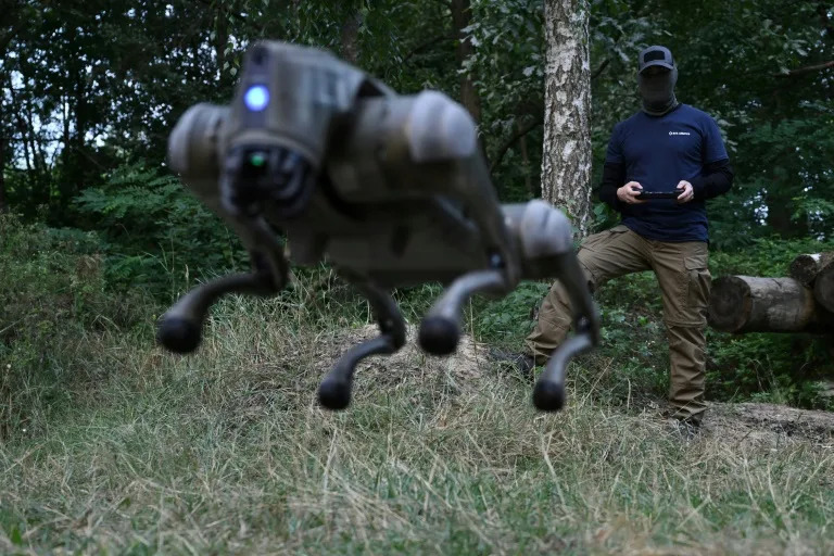 A robot dog leaps into the air, controlled by its operator in Ukraine (GENYA SAVILOV)