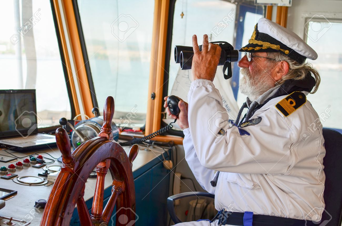 41254602-old-experienced-captain-observes-using-binoculars-by-left-hand-and-holding-radio-comunication.jpg