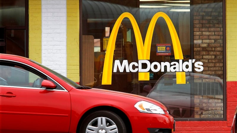 FILE - This Oct. 17, 2011 file photo, cars move through the drive-thru window at a McDonald's...