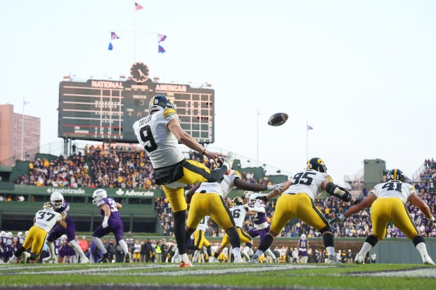 Iowa punter Tory Taylor punts against Northwestern during the second half at Wrigley Field on Nov. 4, 2023. (Michael Reaves/Getty)