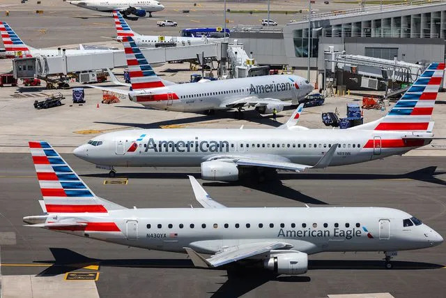 <p>CHARLY TRIBALLEAU/AFP via Getty</p> American Airlines planes at LaGuardia Airport in N.Y.C.