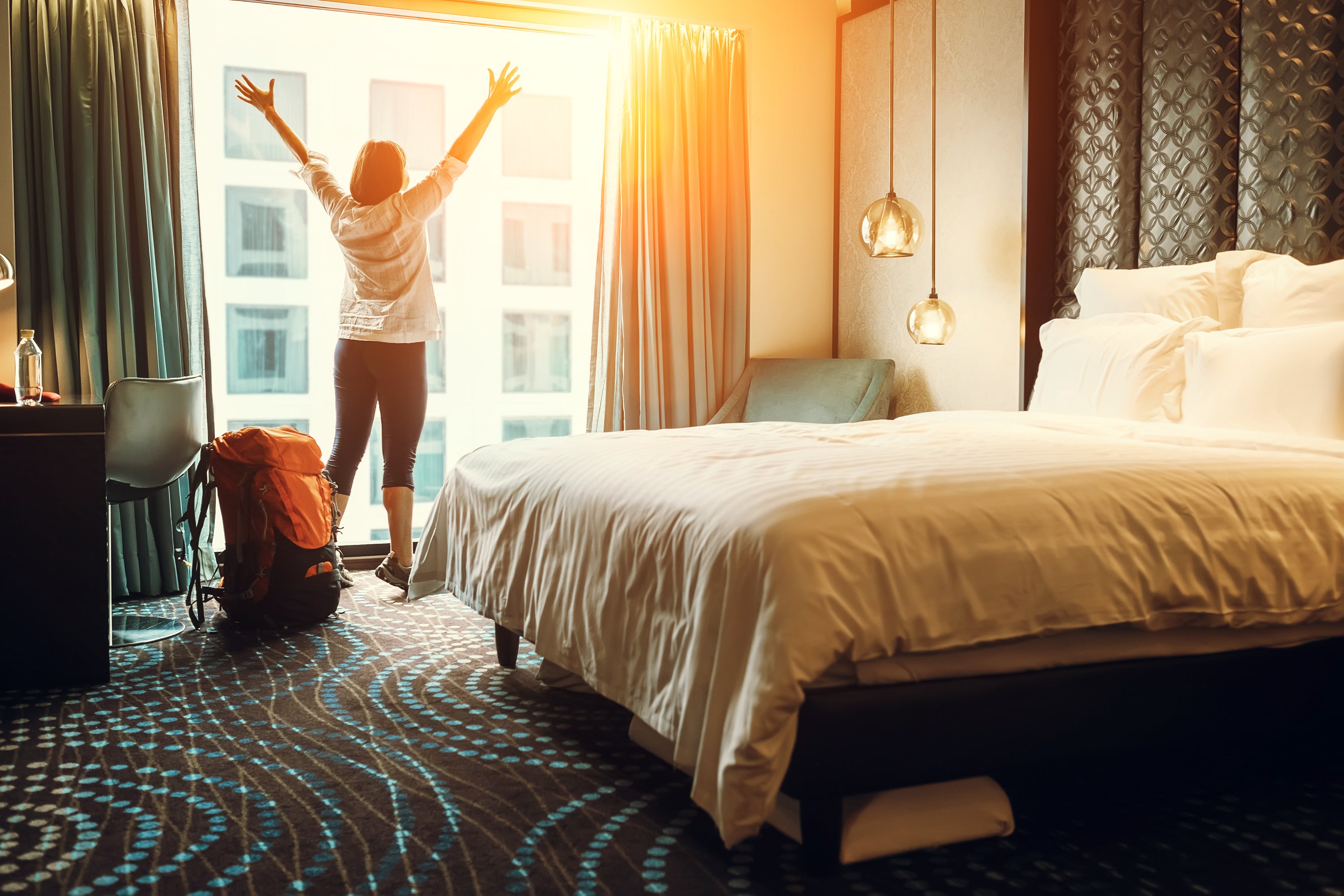 Woman-throwing-open-hotel-curtains.jpg