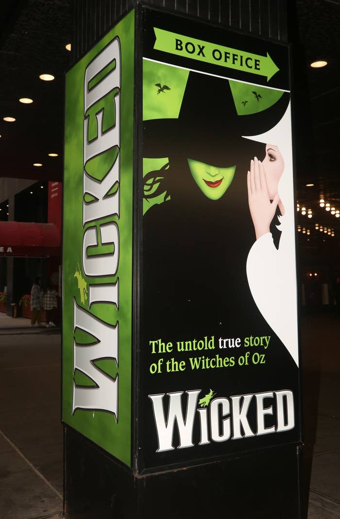 Box office poster for the musical "Wicked" featuring a witch with a green face