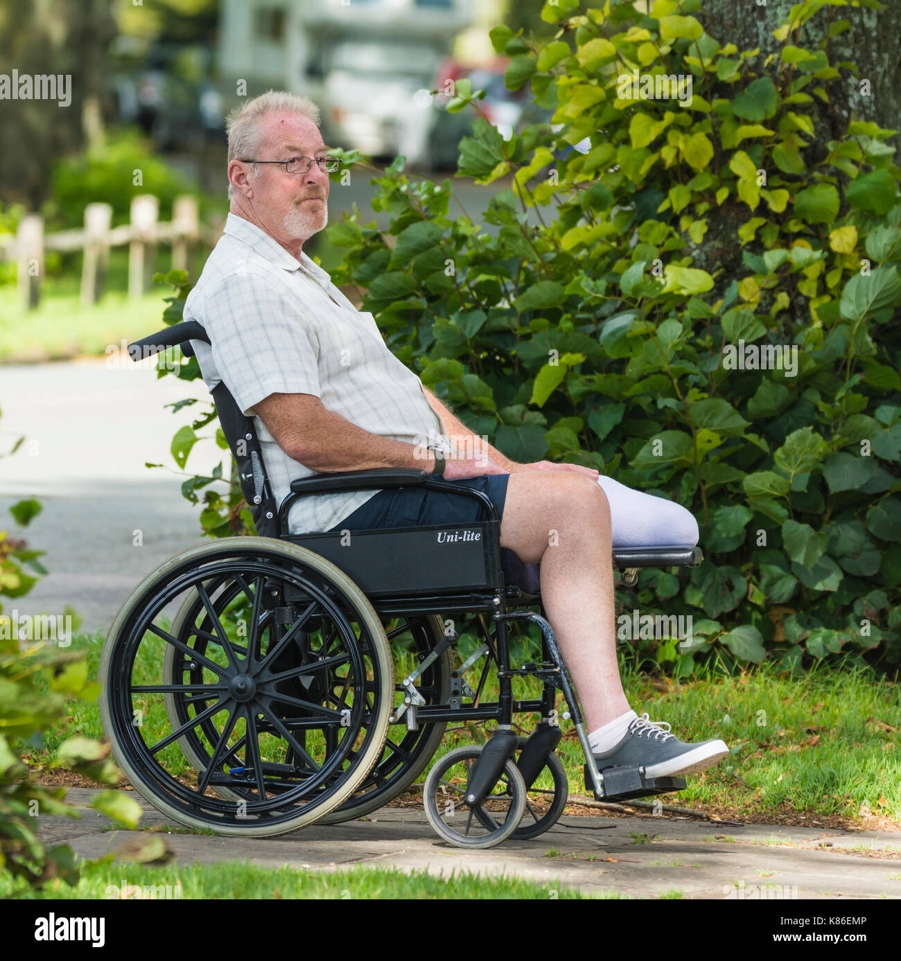middle-aged-man-with-an-amputated-leg-in-a-wheelchair-K86EMP.jpg
