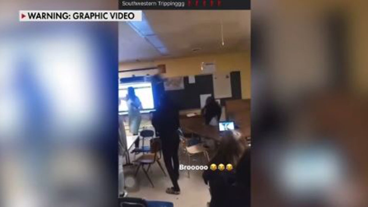 Michigan teacher with chair coming right at her