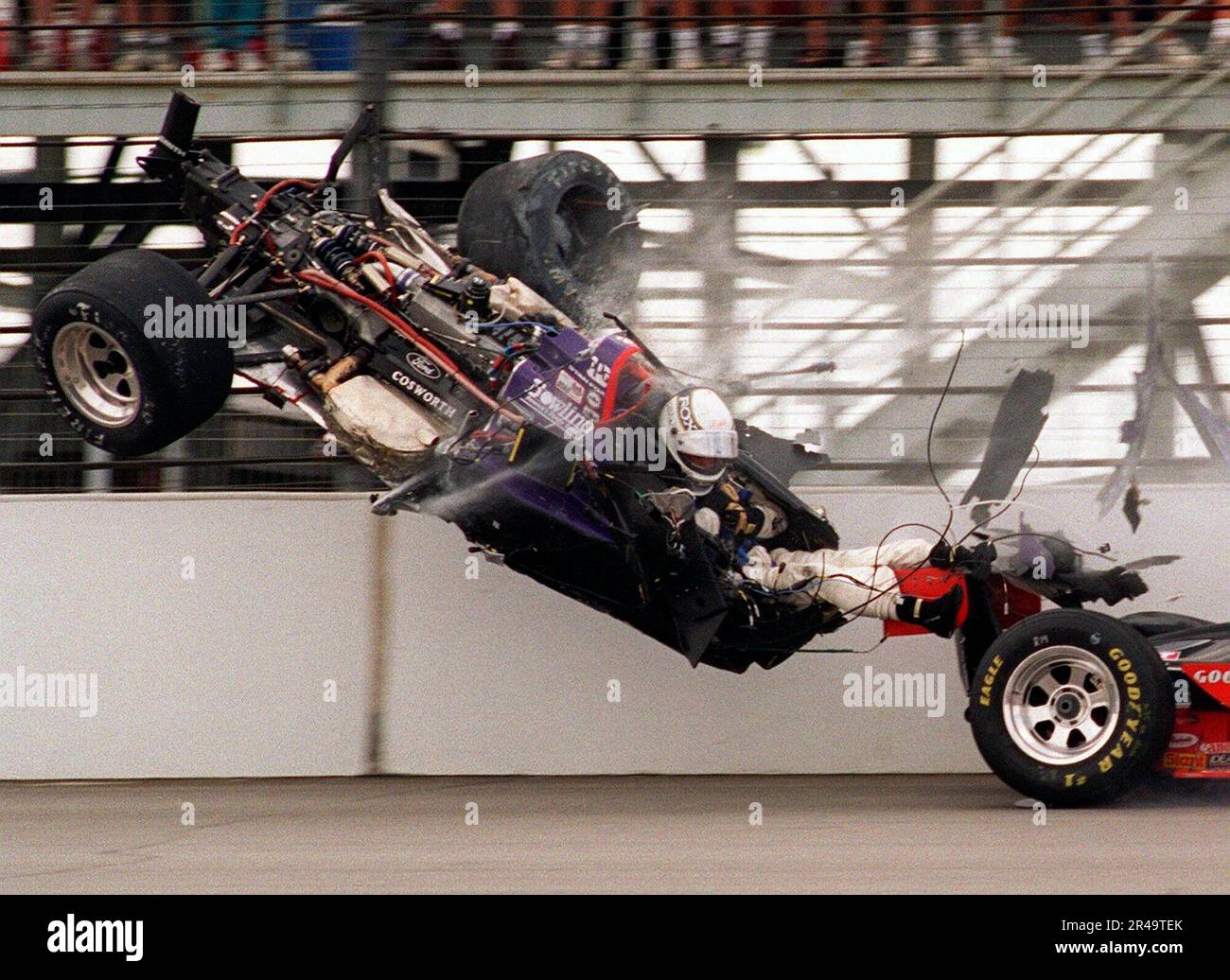 file-stan-fox-his-legs-exposed-sits-in-his-airborne-car-after-the-front-end-was-torn-off-while-slamming-into-the-first-turn-wall-on-the-opening-lap-of-the-indianapolis-500-may-28-1995-foxs-car-had-collided-with-eddie-cheevers-right-both-hitting-the-wall-foxs-legs-were-uninjured-but-he-was-hospitalized-with-serious-head-injuries-following-a-deadly-crash-in-1973-indianapolis-motor-speedway-put-a-number-of-safeguards-in-place-and-eventually-indy-car-cockpits-were-repositioned-to-protect-the-legs-and-feet-of-drivers-and-tubs-were-made-of-stronger-safer-materials-to-increase-safety-2R49TEK.jpg
