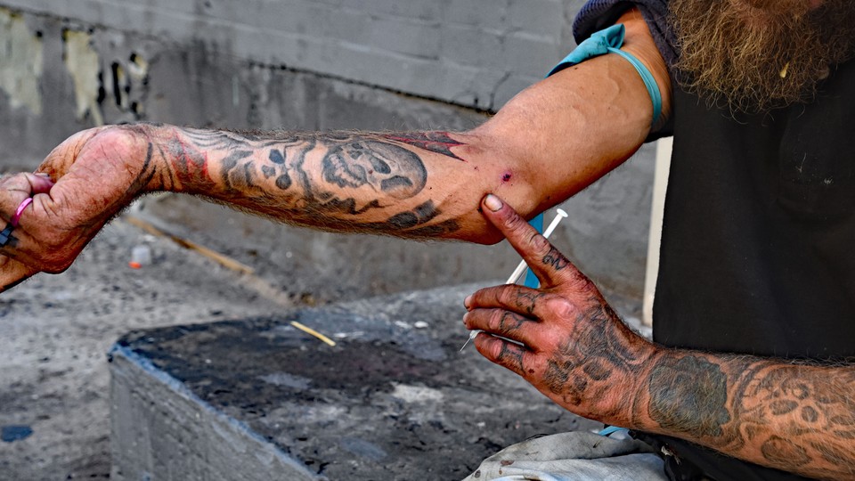 A drug user prepares to inject himself