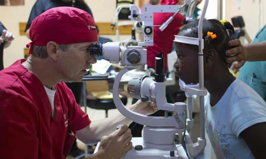 Rand Paul examines the eyes of Natanaelle Jean Louis, 9, during a cataract surgery clinic in Cap-Haitien, Haiti.
