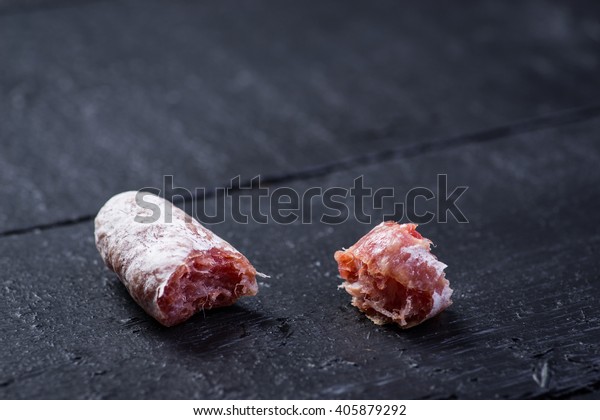 bitten-off-pieces-sausage-on-600w-405879292.jpg