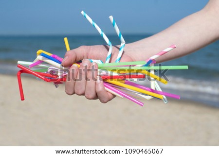 close-hand-holding-plastic-straws-450w-1090465067.jpg