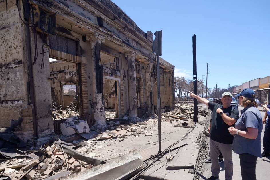 Governor of Hawaii Josh Green, left, and Federal Emergency Management Agency Administrator Deanne Criswell look at a destroyed building Saturday during a tour of wildfire damage in Lahaina, Hawaii. (AP Photo/Rick Bowmer)