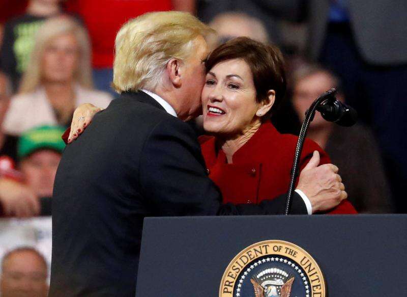 U.S. President Donald Trump embraces Iowa Gov. Kim Reynolds during an Oct. 9, 2018, rally in Council Bluffs. The governor said she intends to thank Trump for allowing summer sales of E15 ethanol and for federal flood aid but share her concerns — when he visits Iowa next week — about his plans to impose tariffs on Mexico. (Reuters) 