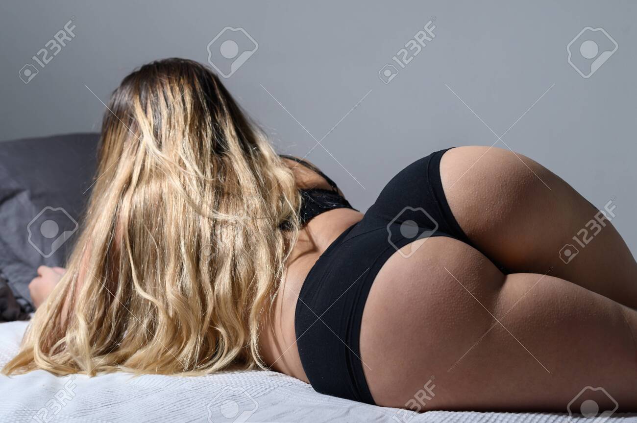 132533825-a-blonde-with-long-hair-in-black-underwear-is-lying-on-the-bed-rear-view-of-a-girl-in-thong-sleeping.jpg