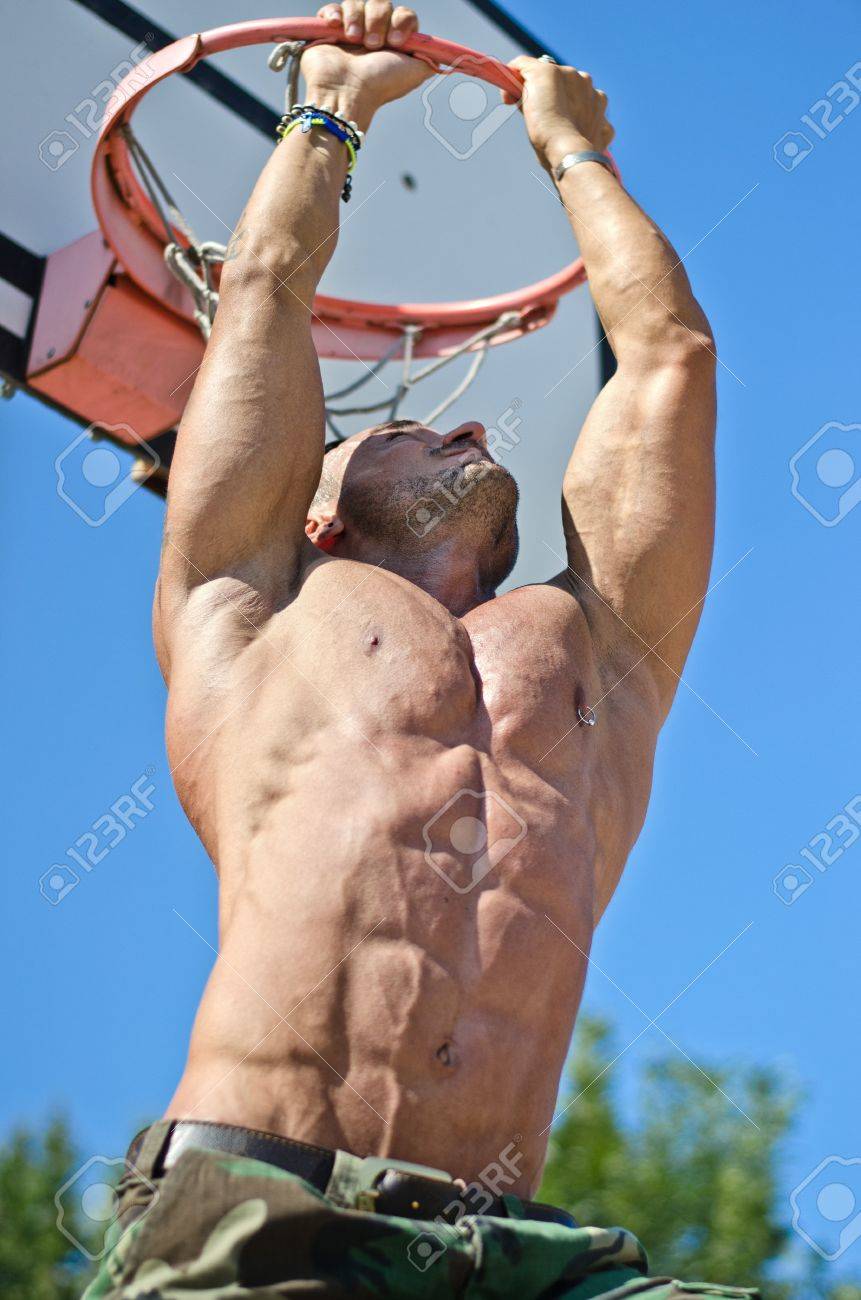 21226298-handsome-muscular-bodybuilder-hanging-from-basketball-ring-outdoors.jpg