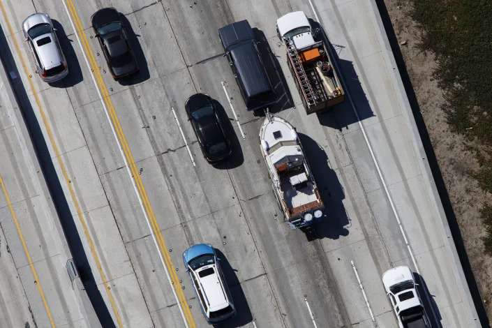 An SUV tows a boat on the heavily traveled 405 Freeway in Los Angeles