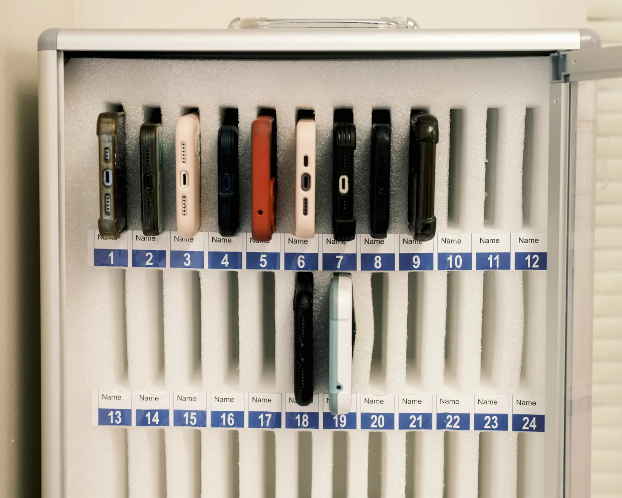 Confiscated cellphones stored in a specialized safe at Timber Creek High School in Orlando, Fla. on Oct. 6, 2023. (Zack Wittman/The New York Times)