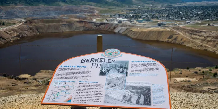 The Berkeley Pit is one of the largest Superfund sites in the US. It is a toxic lake a mile long, a half mile wide, and nearly 1000 feet deep filled with heavy metals and toxic water from old underground copper mine shafts in Butte, Montana.