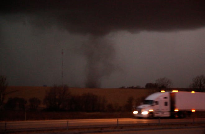 A tornado approaches Interstate 80 near Atlantic, Iowa, as a semi rolls eastward on Wednesday, Dec. 15, 2021. This tornado was an EF2 tornado, was on the ground for 26.1 miles had peak wind speeds of 115 to 120 mph.