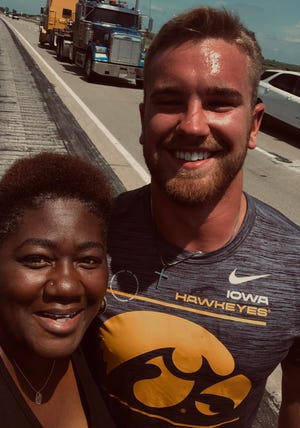 Iowa Hawkeyes linebacker Zach Twedt helped Nebraska resident Tina Gunn and her two sons change a flat tire on their car over the weekend after the family got stuck on the side Interstate 35 in Iowa.