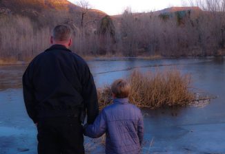 officer-with-boy-looking-at-pond-Washington-County-UT-Sheriffs-Office-FB-326x224.jpg