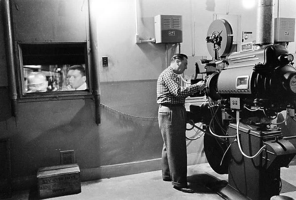 movie-projector-1958-man-working-projector-13636727.jpg.webp