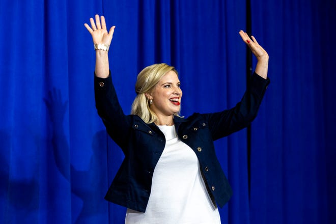 U.S. Rep. Ashley Hinson, R-Iowa, waves to supporters while walking on stage during the Ashley's BBQ Bash fundraiser, Sunday, Aug. 6, 2023, at Hawkeye Downs in Cedar Rapids, Iowa.