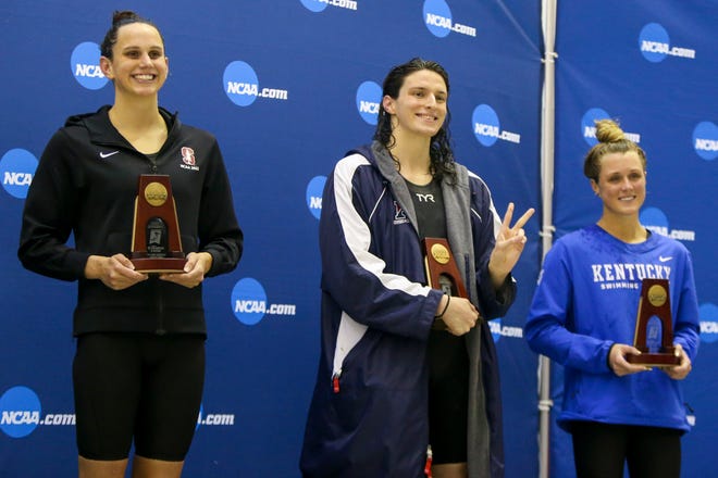 Penn Quakers swimmer Lia Thomas stands between Stanford Cardinal swimmer Lillie Nordmann Kentucky Wildcats swimmer Riley Gaines after finishing fifth in the 200 free at the NCAA Swimming & Diving Championships at Georgia Tech on March 18, 2022 in Atlanta.
