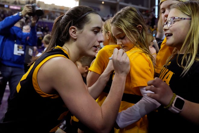 Iowa guard Caitlin Clark signs autographs after Sunday's 94-53 victory at Northern Iowa.