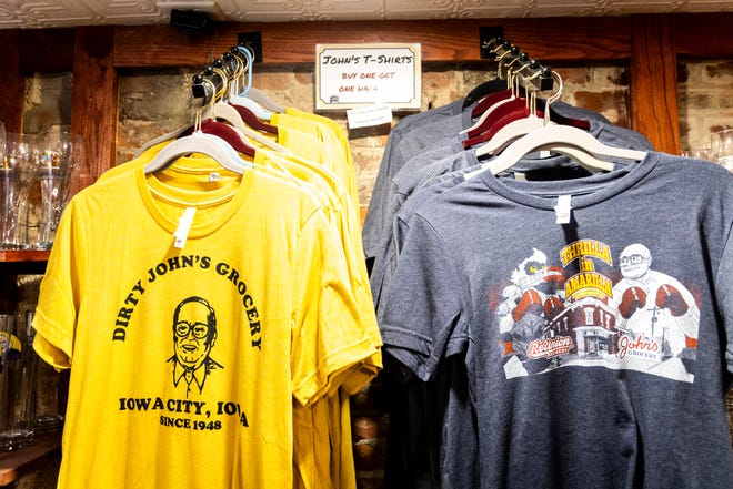 John's Grocery t-shirts are seen displayed for sale, Thursday, Nov. 9, 2023, at John's Grocery in Iowa City, Iowa.