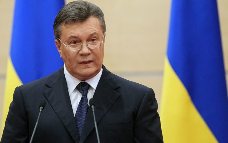 Viktor Yanukovych speaking at a microphone